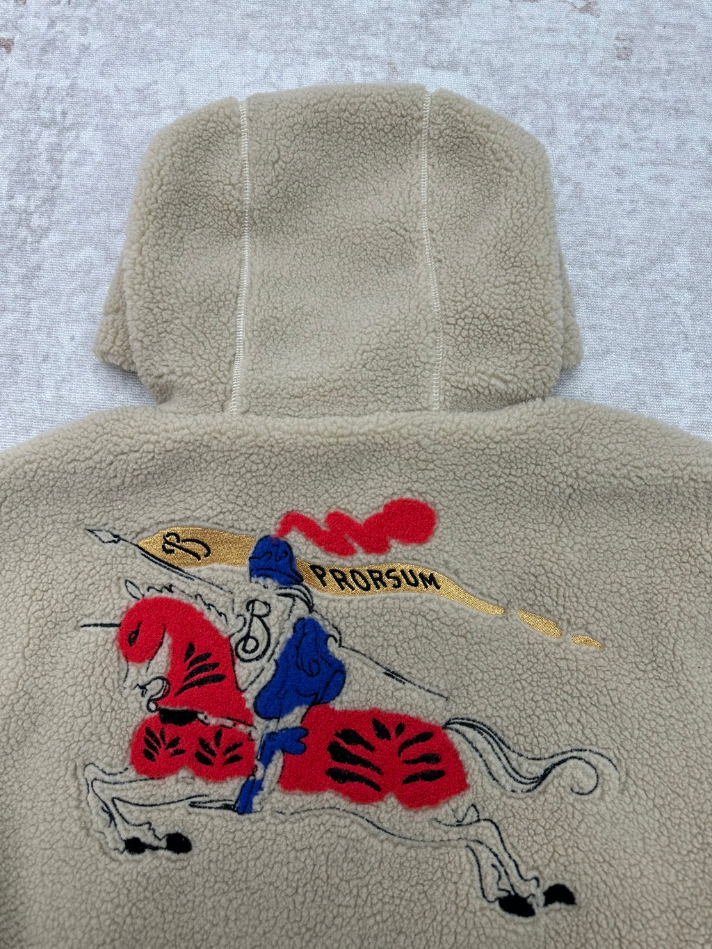 Burberry hooded sherpa jacket back view with large red and blue embroidered graphic