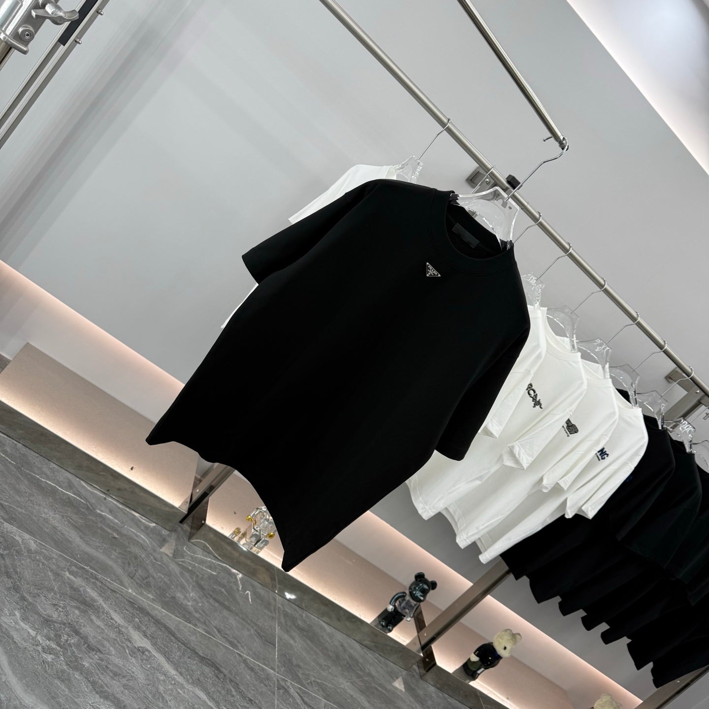 Prada short-sleeve T-shirt, black, angled view with small chest logo