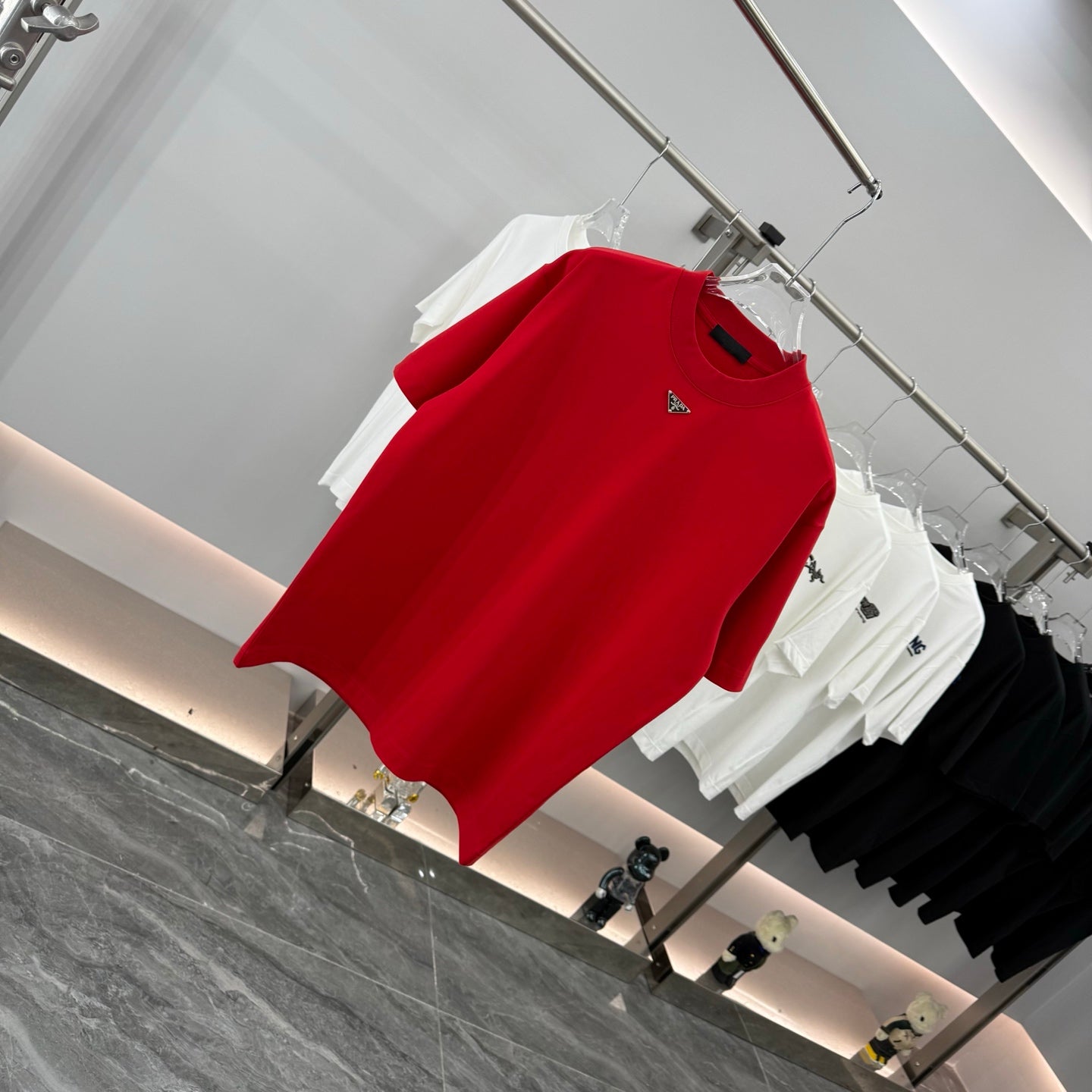 Prada red short-sleeve T-shirt, angled view, crew neck with small triangular logo
