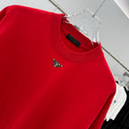 Prada red T-shirt chest close-up with triangular Prada logo patch