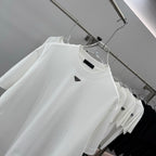 White short-sleeve T-shirt close-up, crew neck and small Prada triangular logo