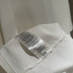 White short-sleeve T-shirt inside label near hem seam