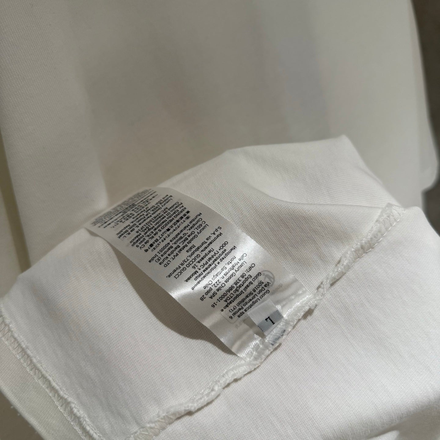 White short-sleeve T-shirt inside label near hem seam