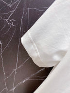 Versace white T-shirt sleeve cuff close-up