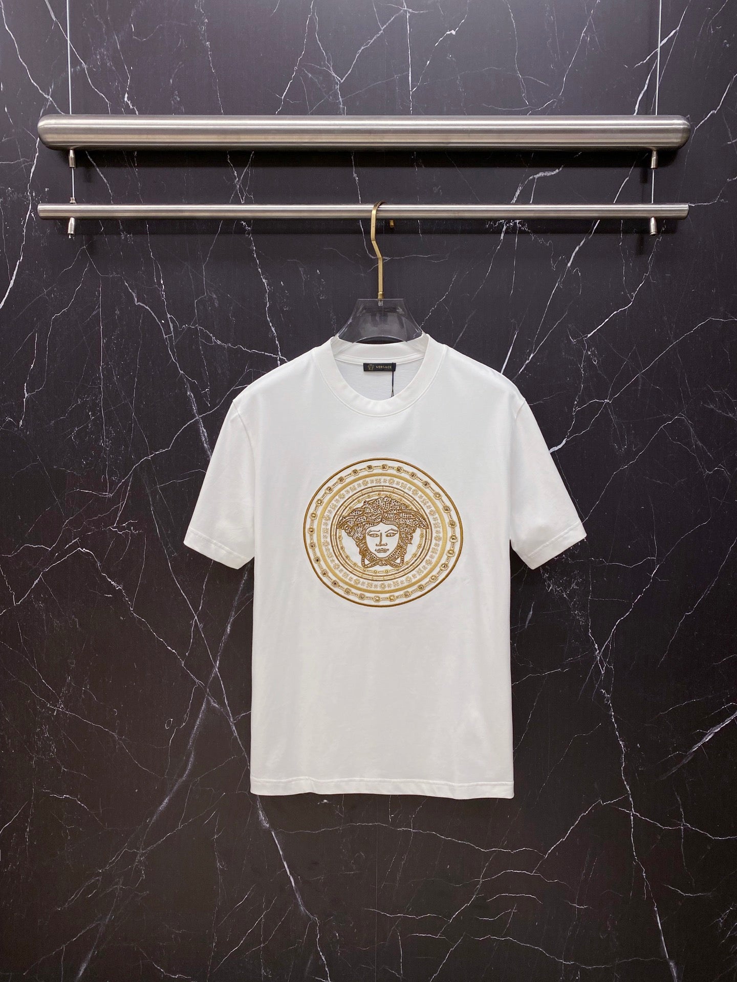 Versace white crewneck T-shirt with gold ornate medallion graphic on chest