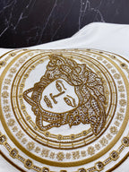 Versace white T-shirt close-up of gold ornate face medallion print