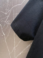 Versace black T-shirt sleeve and side hem close-up