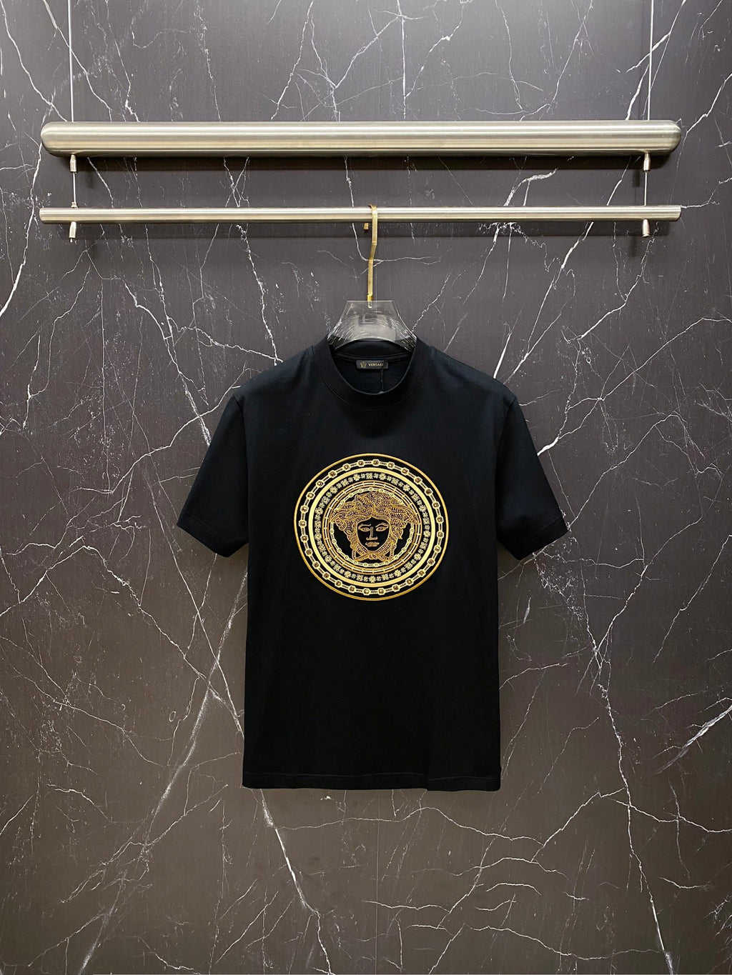 Versace black T-shirt with gold circular Medusa logo on chest