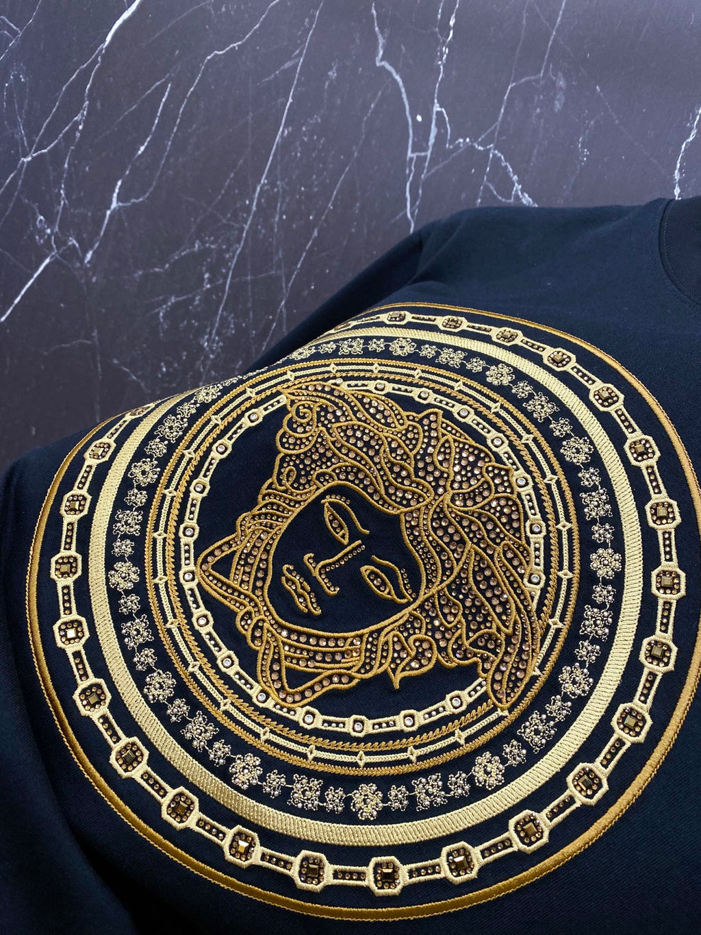 Versace black T-shirt chest graphic with gold Medusa medallion