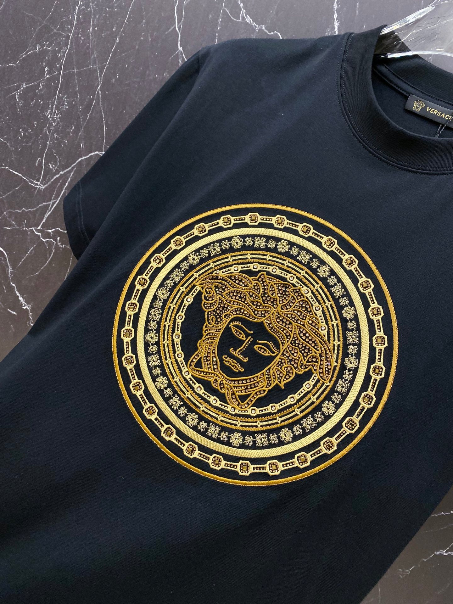 Versace black T-shirt with large gold Medusa medallion graphic