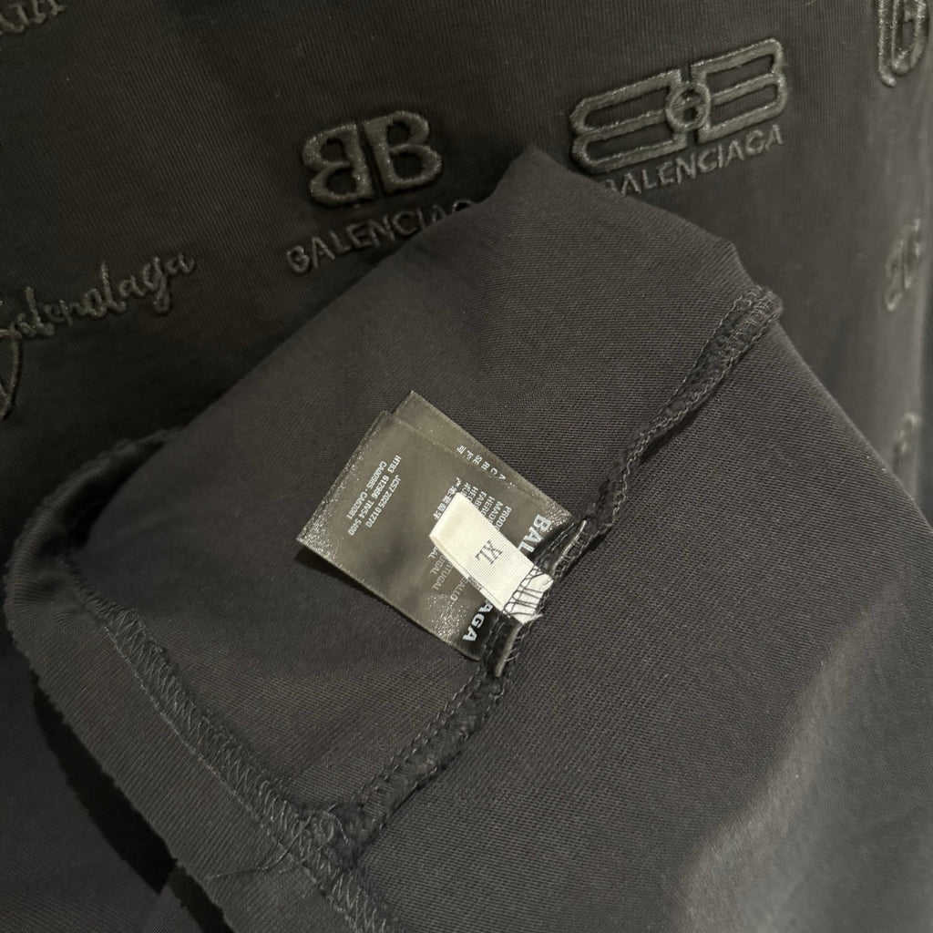 Black T-shirt sleeve fabric close-up with care label