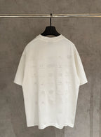 Balenciaga white T-shirt back view with allover embossed logo pattern on a hanger