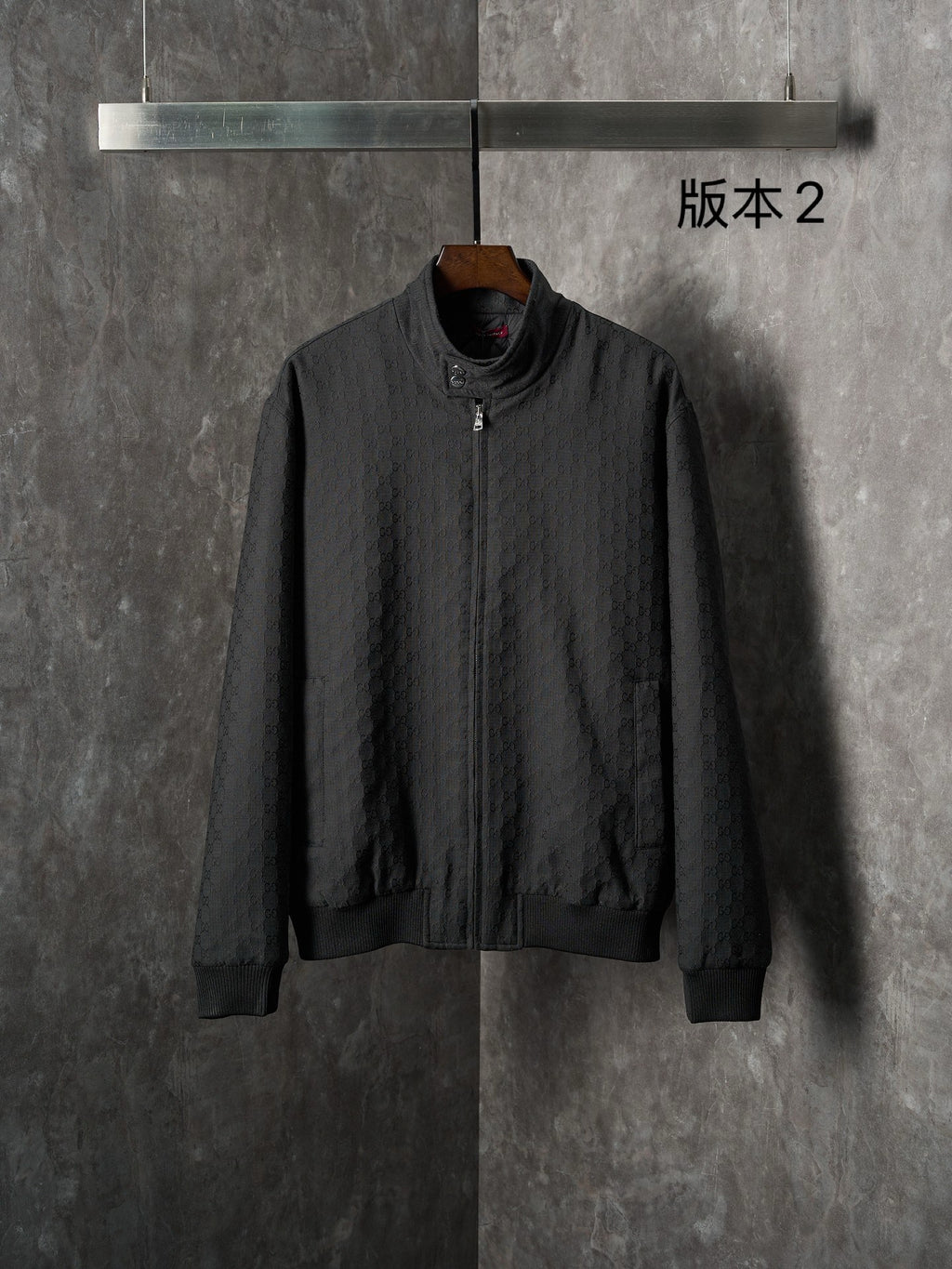 Gucci long jacket in dark fabric with allover GG pattern, front zipper, ribbed cuffs