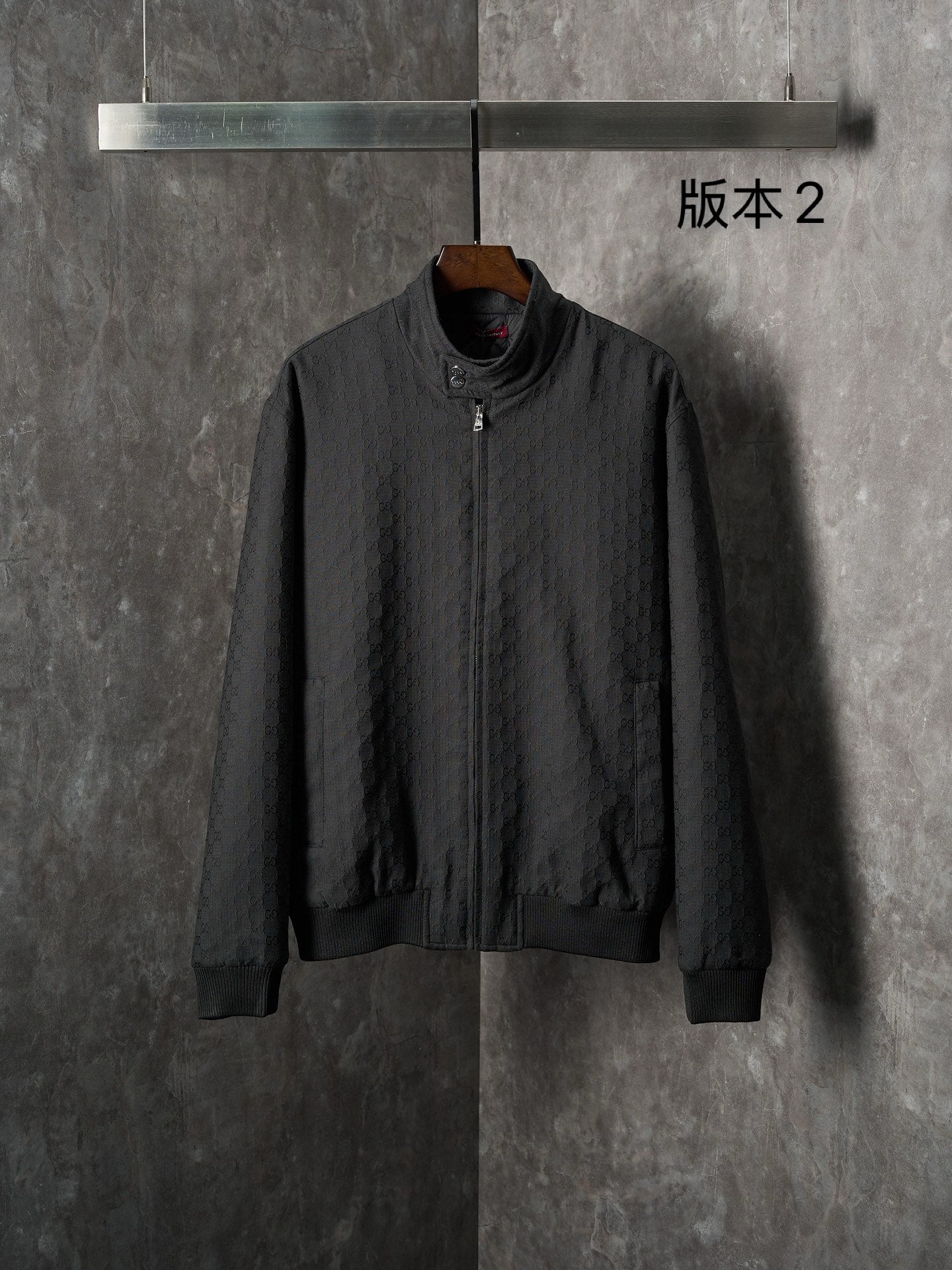 Gucci long jacket in dark fabric with allover GG pattern, front zipper, ribbed cuffs