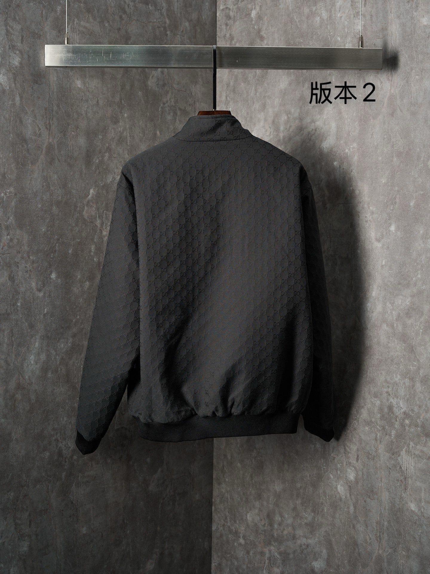 Long jacket, back view in dark allover GG pattern with center zipper
