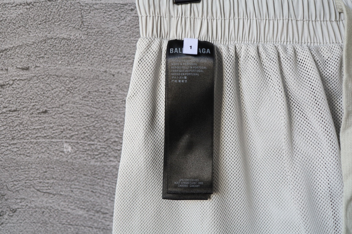 White pants with interior care label tag attached near waist