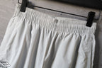 White pants with elastic waistband and wide pleated leg silhouette