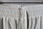 White pants with elastic waistband and textured mesh underlayer