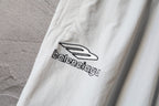 White pants with black Balenciaga logo print on the leg