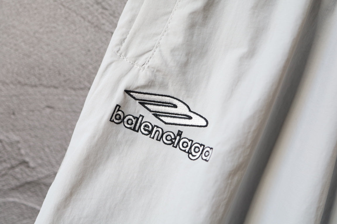 White pants with black Balenciaga logo print on the leg