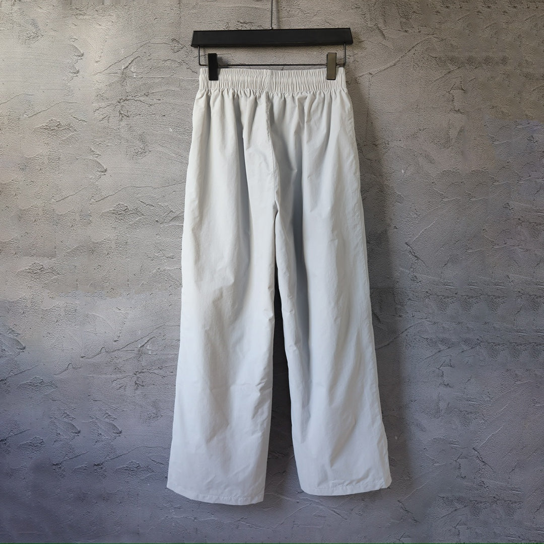 White wide-leg pants with elastic waistband, hanging display