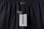 Black Balenciaga pants with hanging brand tag at waistband