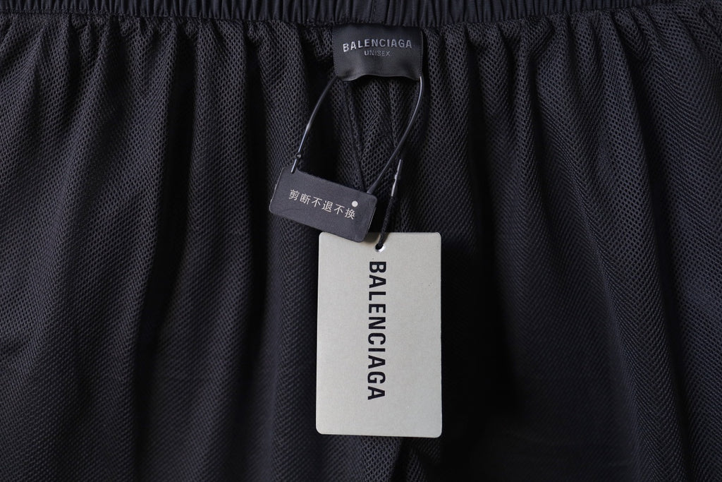 Black Balenciaga pants with brand hang tag on waistband.