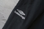 Black pants leg with Balenciaga logo print near the knee