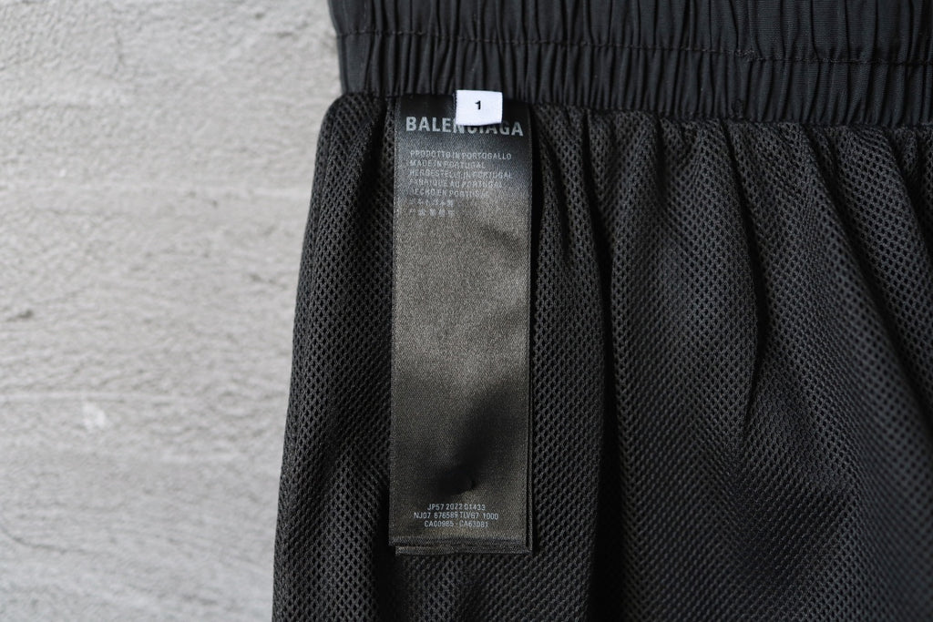 Black Balenciaga pants interior with size label and mesh lining