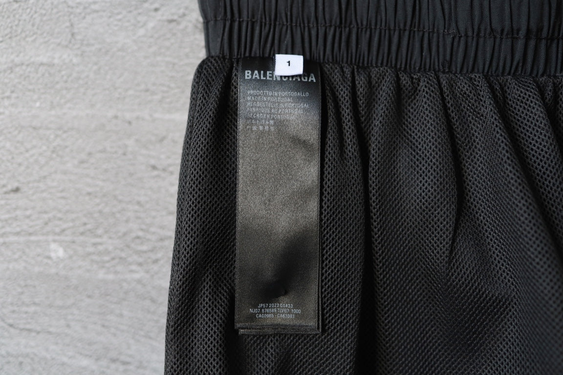 Black Balenciaga pants with interior size label tag visible near waistband.