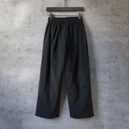 Black wide-leg pants with elastic waistband and subtle front logo detail