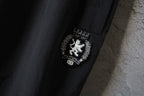 Black Balenciaga pants with crest patch detail near the side seam