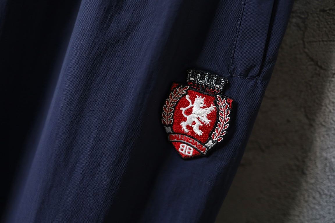 Crest logo patch on navy pants leg