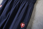 Balenciaga pants gathered waist and crest patch on dark navy leg
