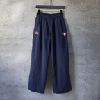 Navy Balenciaga wide-leg pants with elastic waistband and side logo patches