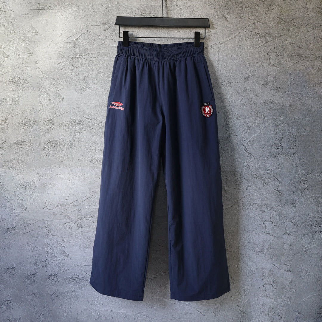 Navy Balenciaga wide-leg pants with elastic waistband and side logo patches
