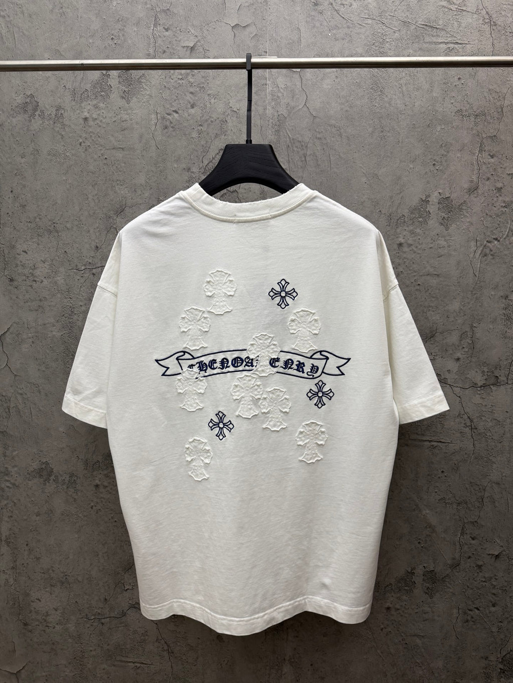 White short-sleeve T-shirt with large back graphic: blue banner text and snowflake appliques