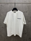 White short-sleeve T-shirt with small chest logo graphic in blue and white texture