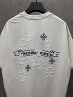White short-sleeve T-shirt back view with blue banner text and raised snowflake appliques