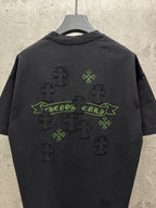 Black short-sleeve T-shirt back view with green banner and clover cross icons