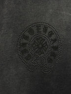 Dark gray T-shirt fabric with circular rhinestone skull emblem detail