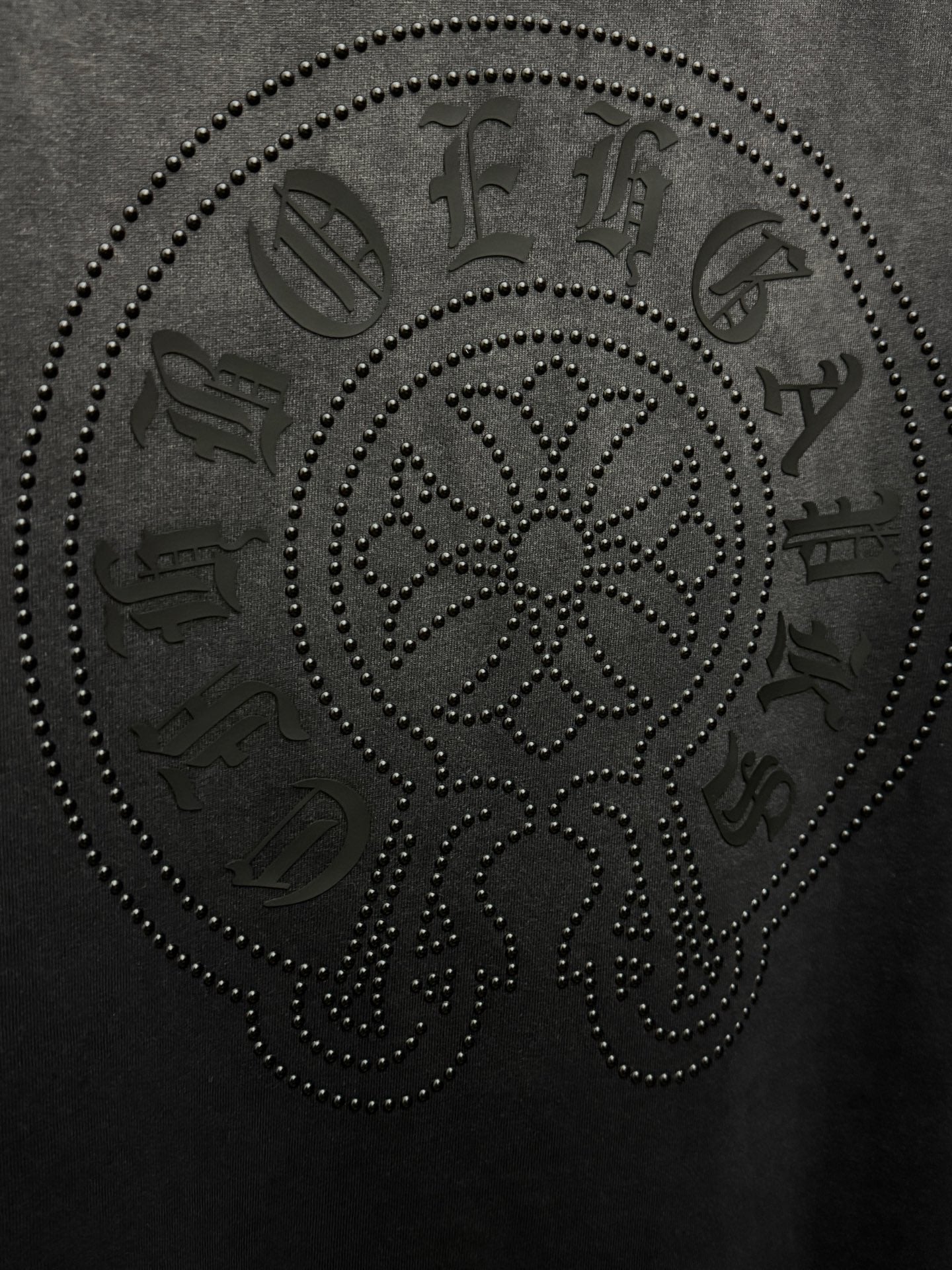 Dark gray T-shirt with large rhinestone skull face graphic, text accents