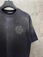 Dark short-sleeve T-shirt with small round chest logo studded with accents