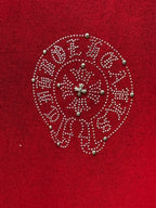 Red T-shirt with close-up of circular rhinestone logo with green and gold accents