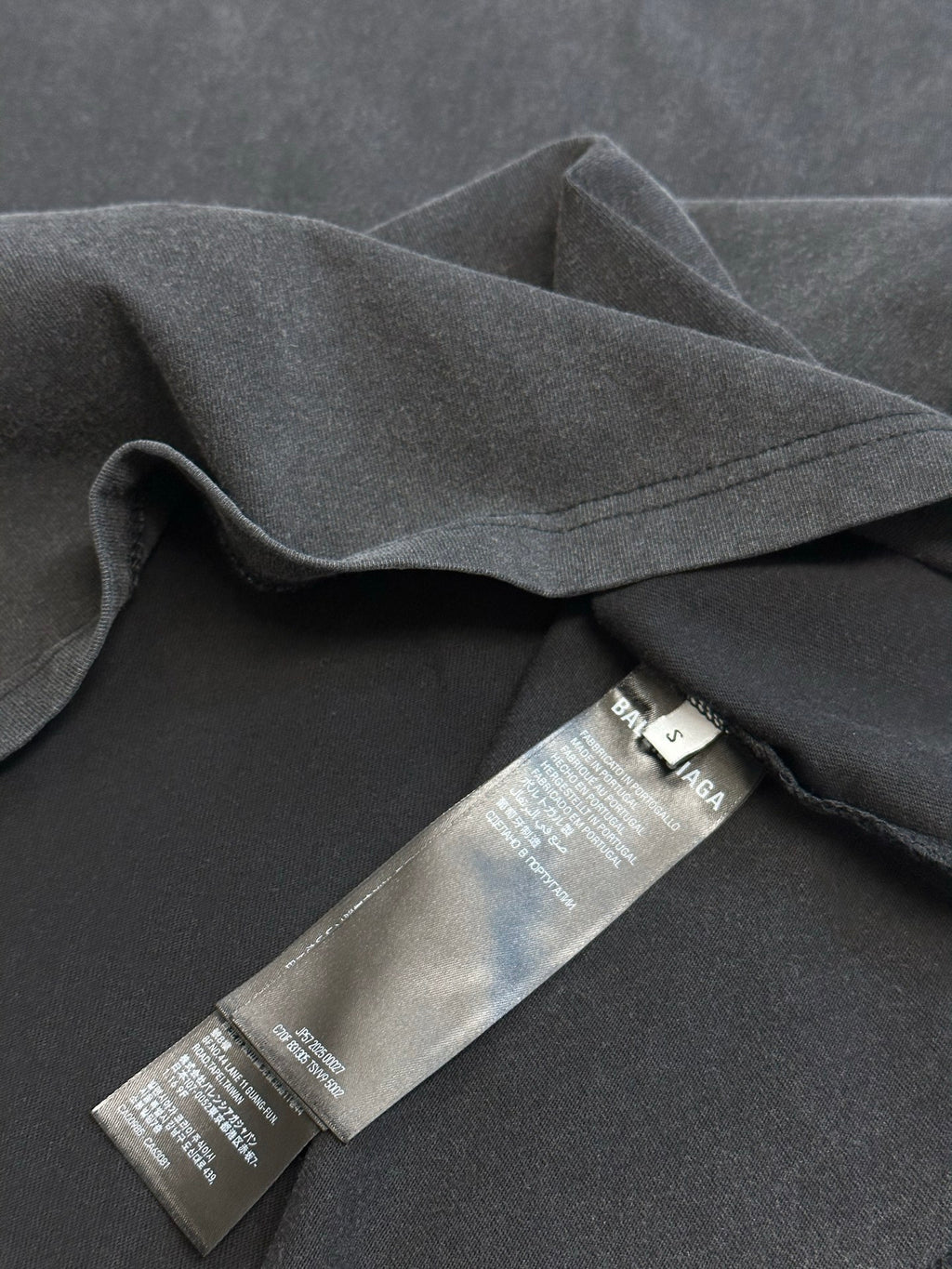 Dark gray T-shirt with inner care label on fabric seam