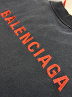 Dark gray T-shirt with large red Balenciaga lettering logo across chest