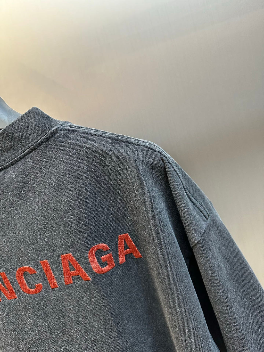 Dark gray T-shirt back panel with large red Balenciaga logo print