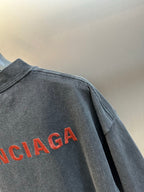 Dark gray T-shirt back panel with large red Balenciaga logo print