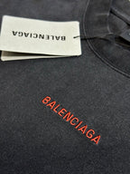 Dark gray T-shirt fabric with Balenciaga logo and white brand label tag
