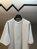 T-shirt in light gray with short sleeves and crew neckline on hanger